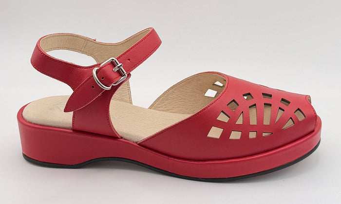 A red platform wedge sandal with a cutout toe and ankle strap, displayed inside a white lightbox on a black stand.